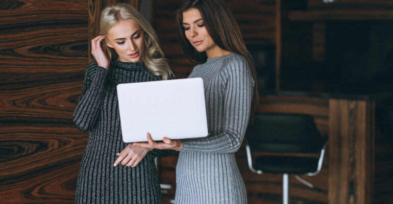Two business woman with computer