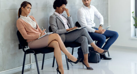 Small group of business people waiting for job interview in a ha