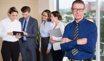 Senior Business Leader Standing in Front of Team