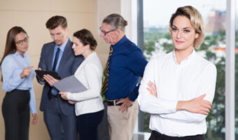 Successful Businesswoman Standing in Front of Team